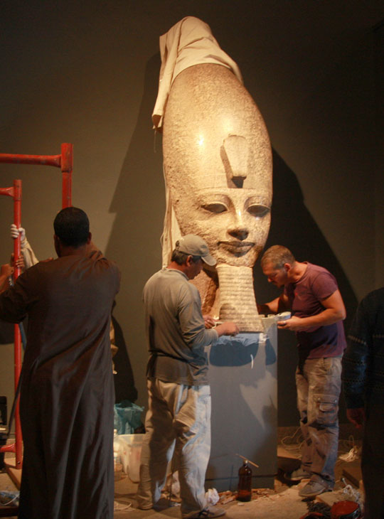 Conservators join the beard to the head of Amenhotep III.