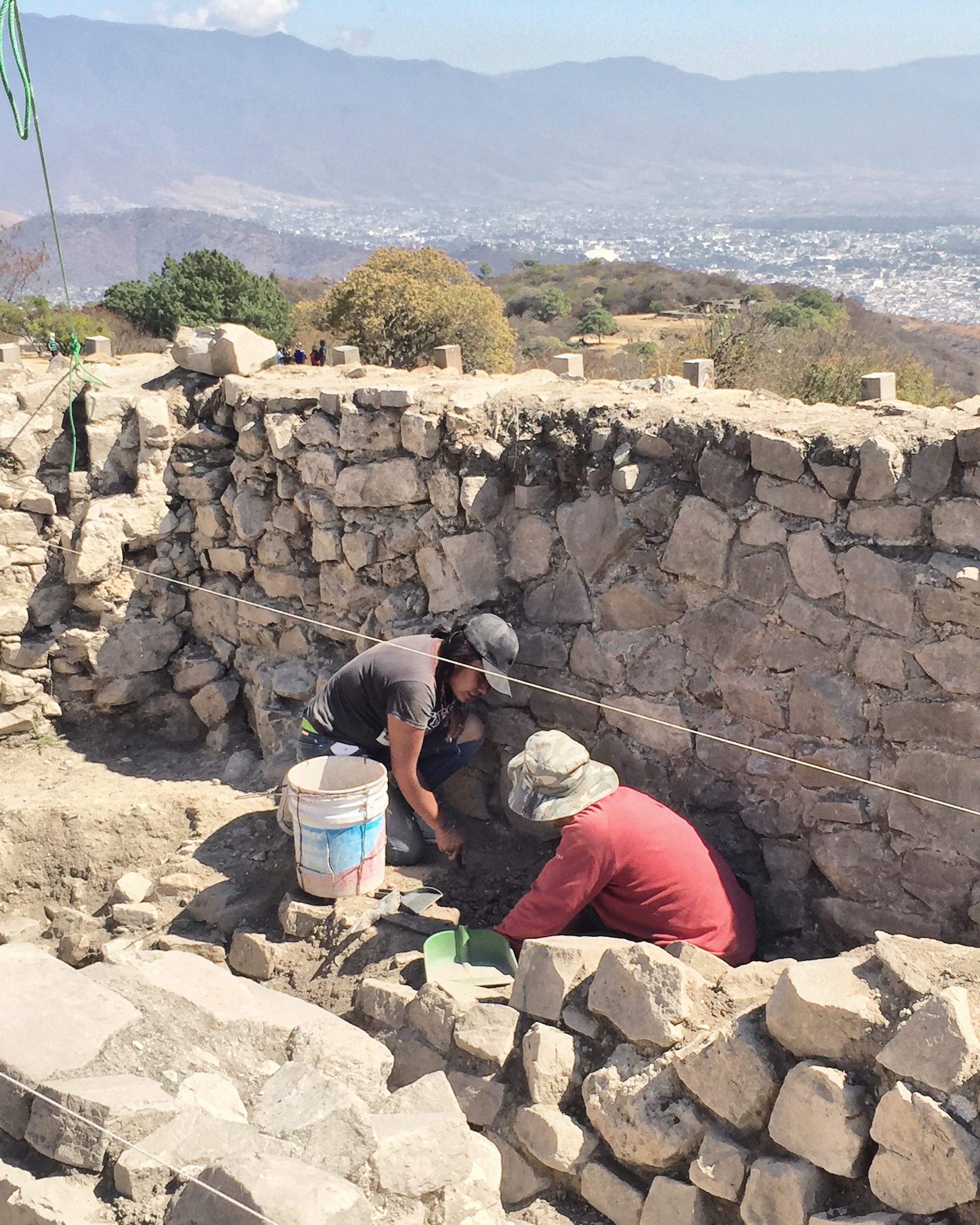 Removing, cleaning, and classifying  little archaeological findings on the top of a pyramid in Monte Albán.