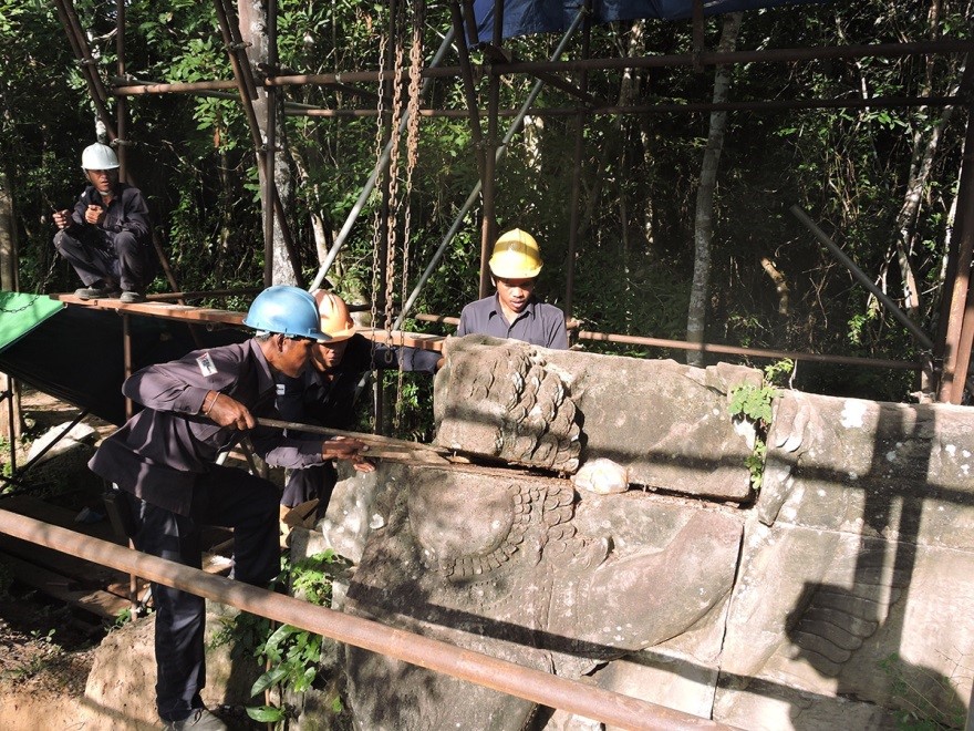The conservation team dismantling one of the stone units that forms the Garuda