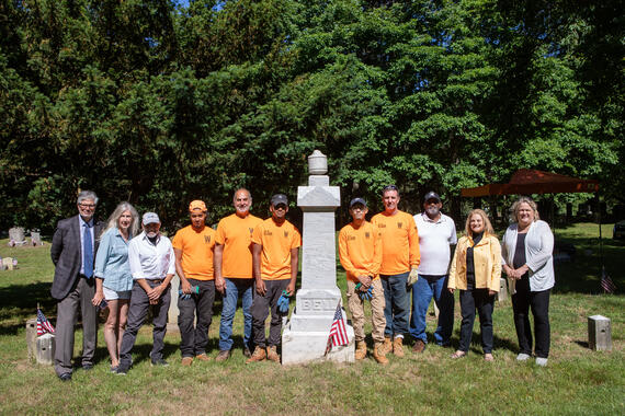 From left to right, standing next to the Bell Family monument: Nicholas Pisano, Vice President & Chief Financial Officer, WCC; Suzanne Clary, President, JHC; Frank Sanchis, WMF; Oliver Moran Sepulveda, Apprentice; Robert Cappiello, Resident Craftsman; Jonathan Mendoza, Apprentice; Kenny Tuy, Apprentice; Gerald Dowd, Assistance Craftsman; Dave Thomas, Founder, FOACC; Debbie Reisner, Town of Rye; Susan Olsen, Director of Historical Services; Maxwell Pisano, Preservation Intern.