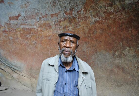 David Ngwenya before the endangered rock art of Matobo Hills.