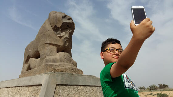 A young visitor at the Lion of Babylon, Iraq, 2016.