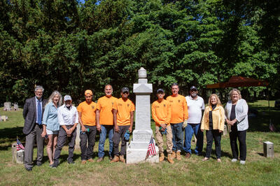 From left to right, standing next to the Bell Family monument: Nicholas Pisano, Vice President & Chief Financial Officer, WCC; Suzanne Clary, President, JHC; Frank Sanchis, WMF; Oliver Moran Sepulveda, Apprentice; Robert Cappiello, Resident Craftsman; Jonathan Mendoza, Apprentice; Kenny Tuy, Apprentice; Gerald Dowd, Assistance Craftsman; Dave Thomas, Founder, FOACC; Debbie Reisner, Town of Rye; Susan Olsen, Director of Historical Services; Maxwell Pisano, Preservation Intern.
