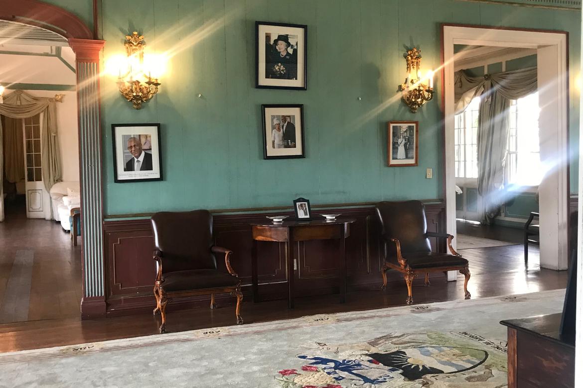 The entrance hall in the main house with photographs of the Governor General and Queen Elizabeth II 