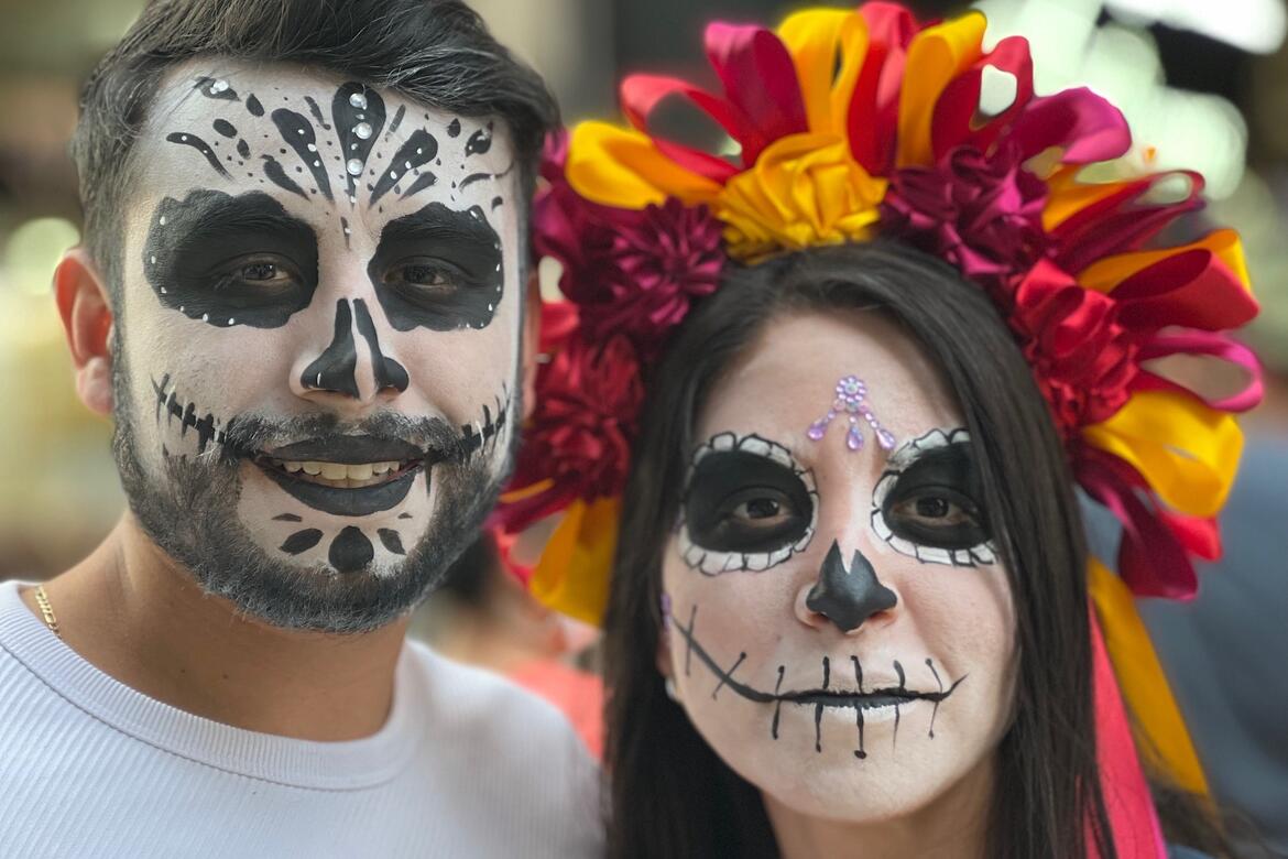 Portrait of two young people dressed for Dia de los Muertos festivities in Mexico City.