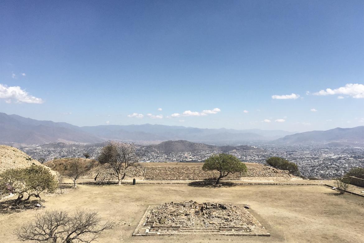 The view of Atzompa's highest square from the main pyramid and with the city of Oaxaca and its mountainous landscape in the background.