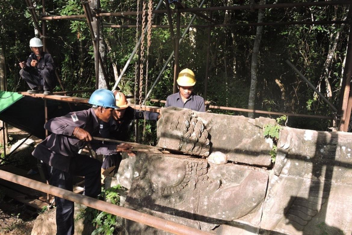 The conservation team dismantling one of the stone units that forms the Garuda