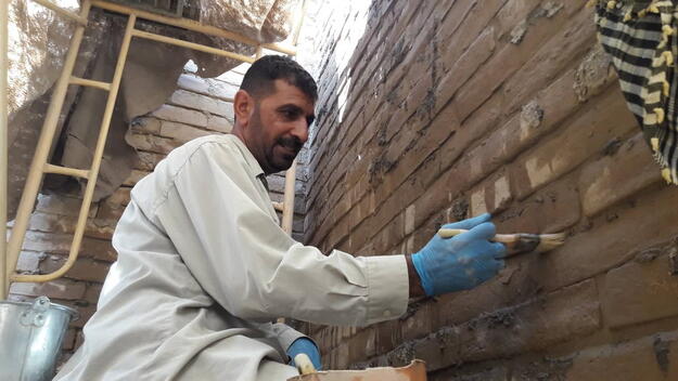 Mohaned Jwer infilling missing Ishtar Gate brick repointing, October 2019.