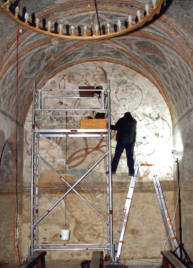 Conservator working on the wall murals, 2004