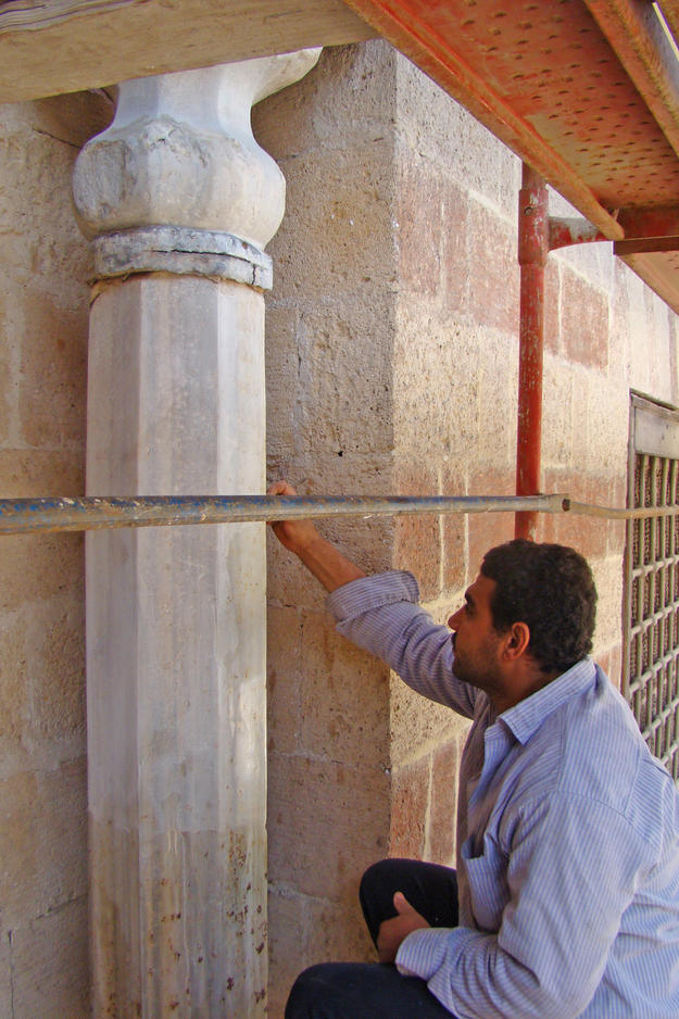Conservator working on the southwest interior wall , 2011