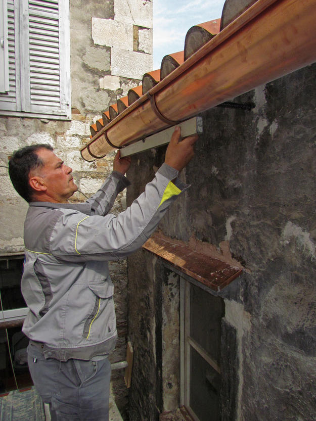 Installing a new copper gutter on the southern side of the roof , 2014