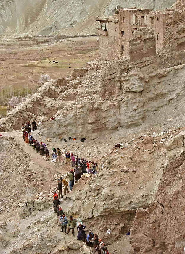 Villagers carry stone to the Serzang temple for the construction of the retaining wall, 2004