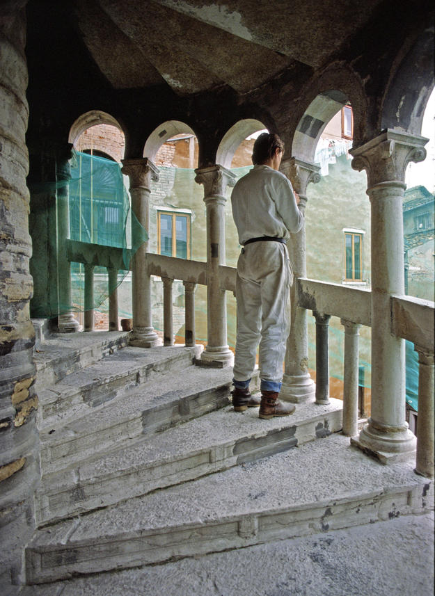 A conservator stands on the reconsolidated steps, 1981