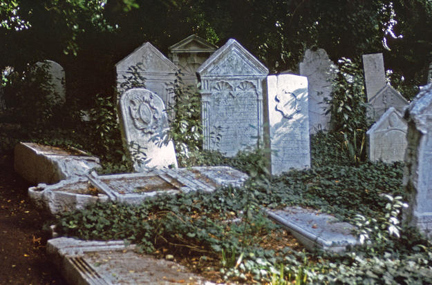Scattered and broken tombstones, 1975