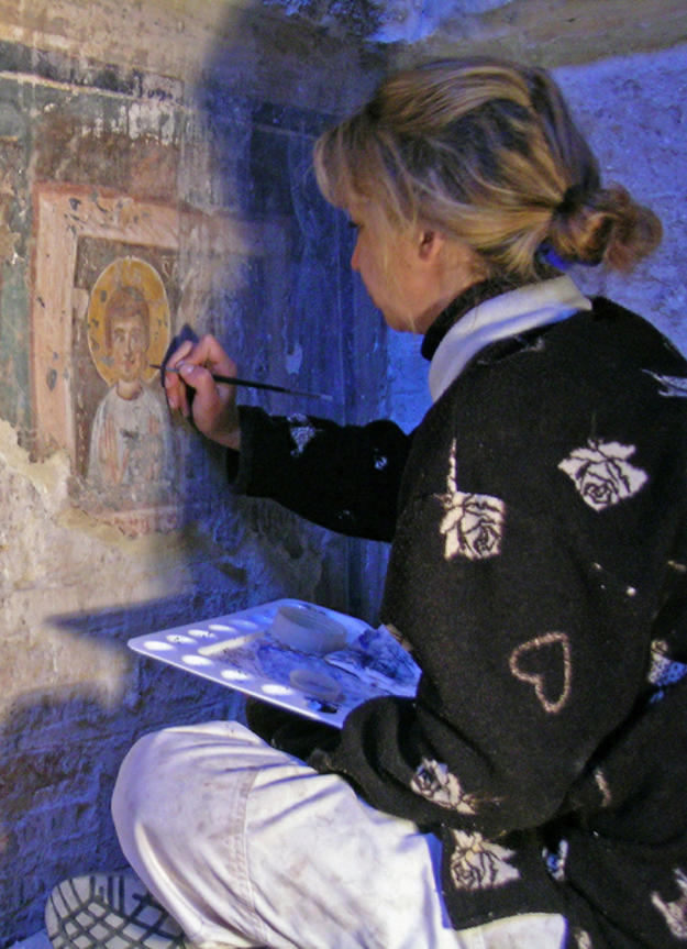 A conservator works on a wall painting , 2007