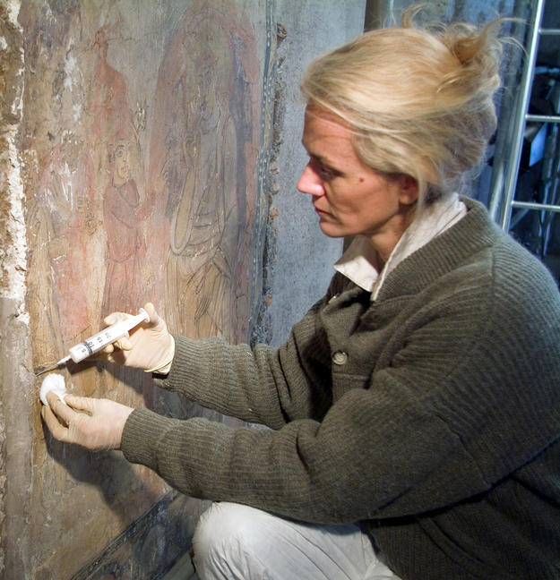 A conservator preserving a medieval fresco, Feb-07