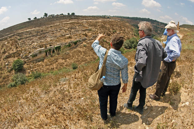 Conservators look towards the site from the opposite side of Wadi bel Ghadir, 2013