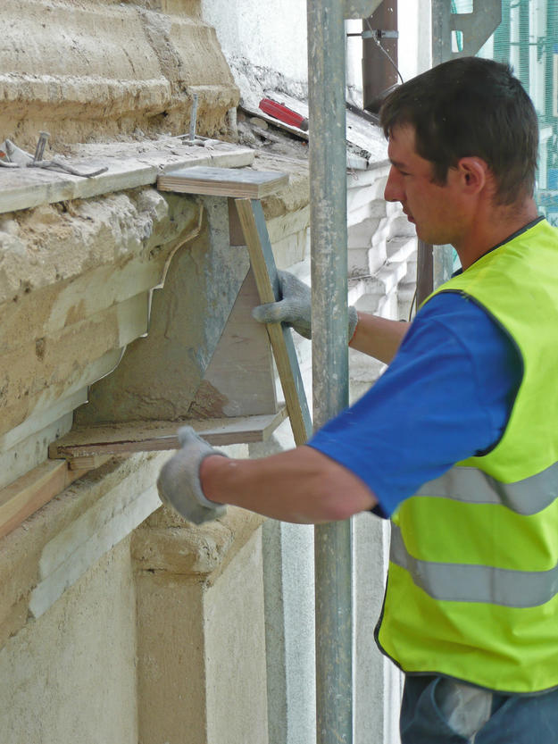 Conservator applying new plaster to the north façade of the northern annex, 2010