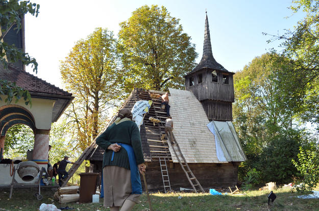 A villager watches the repairs of the roof of the church of Tarnavita, 2012