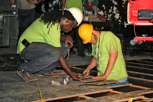 A field program student learns how to repair the stage floorboards, 2009