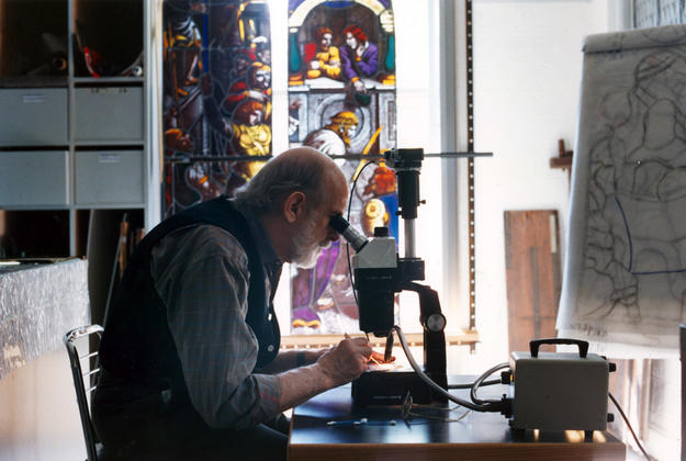 Master glass conservator Melville Greenland preparing a sample for photo documentation, 1990