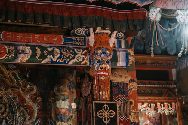 Colorfully painted wood, including faces of mythological creatures.