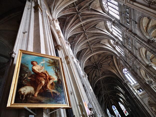 The painting of Saint John the Baptist by François Lemoyne against a view of the church's remarkable mix of gothic and renaissance architecture.