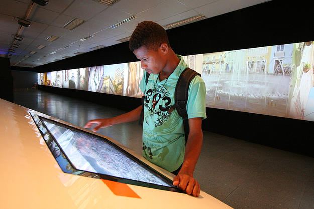 A visitor to the exhibition enjoys the interactive media, 2013