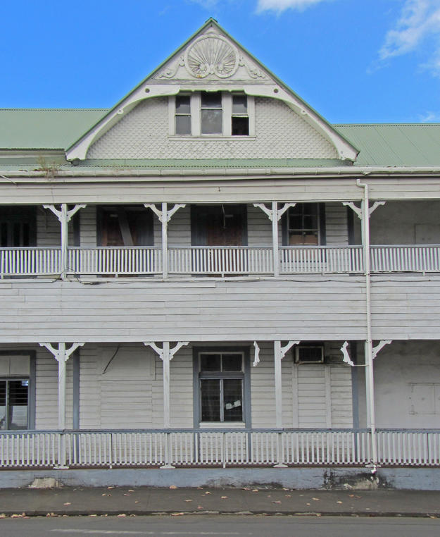 The façade along the waterfront shows the building's full-length verandas on the lower and upper stories, 2013