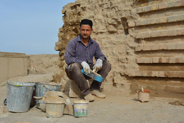 WMF conservation technician Aad Khazal, in front of old (left) and new (right) masonry, became a lead in handling both masonry types, particularly how to integrate the two to reduce their contrasting patterns visually.