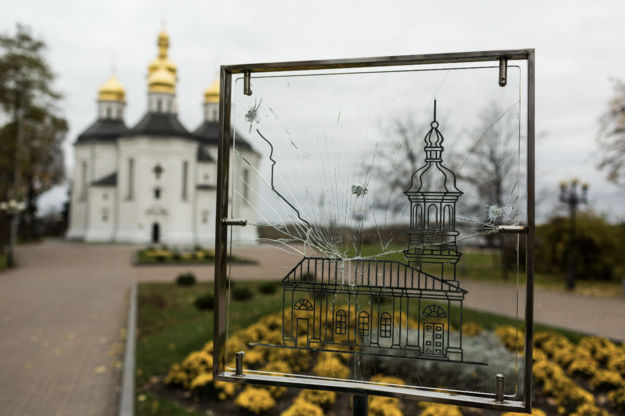 Broken glass in foreground with gold-domed Orthodox church in background