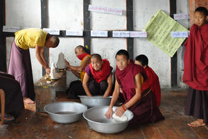 Monks preparing votive offerings, July 2010