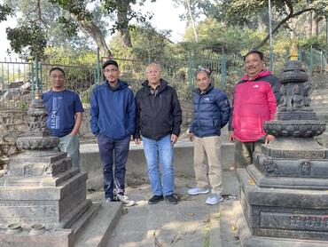 Amar (far left) and CCO President Prabodh Kasaa (center) with CCO team members beside two chivas in the Kathmandu Valley, Nepal.