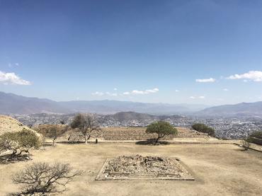 The view of Atzompa's highest square from the main pyramid and with the city of Oaxaca and its mountainous landscape in the background.