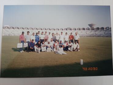 Ravindra Joshipura (back row, center, wearing a blue hat), on the day he played his last match at Patel Stadium. He played for the Reserve Bank of India team until retiring in 2007.